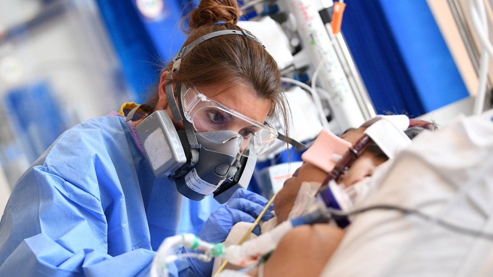 Clinical staff wear Personal Protective Equipment as they care for a patent at the Intensive Care unit at Royal Papworth Hospital