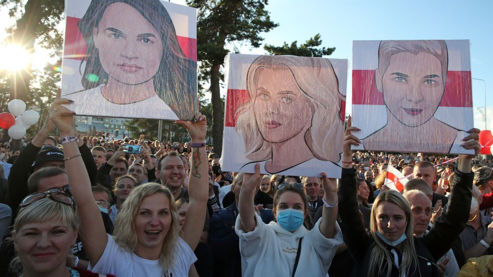 Women hold portraits of Svetlana Tikhanovskaya, Veronika Tsepkalo and Maria Kolesnikova (L-R) as they take part in a rally in support of Belarusian presidential candidate Svyatlana Tsikhanowskaya.