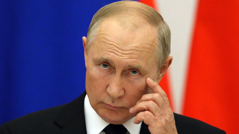 Vladimir Putin with hand to face