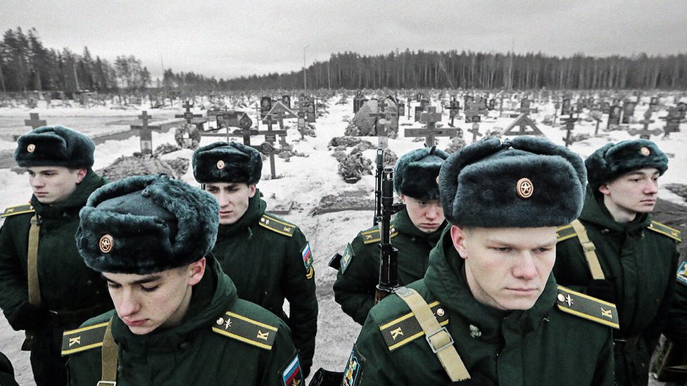صورة لطلاب روس يقفون في مقبرة