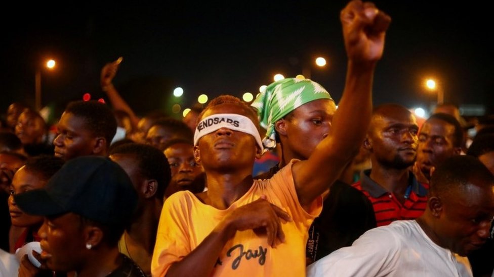 A demonstrator wearing a blindfold with an inscription "End Sars", gestures during protest against alleged police brutality in Lagos, Nigeria October 17, 2020
