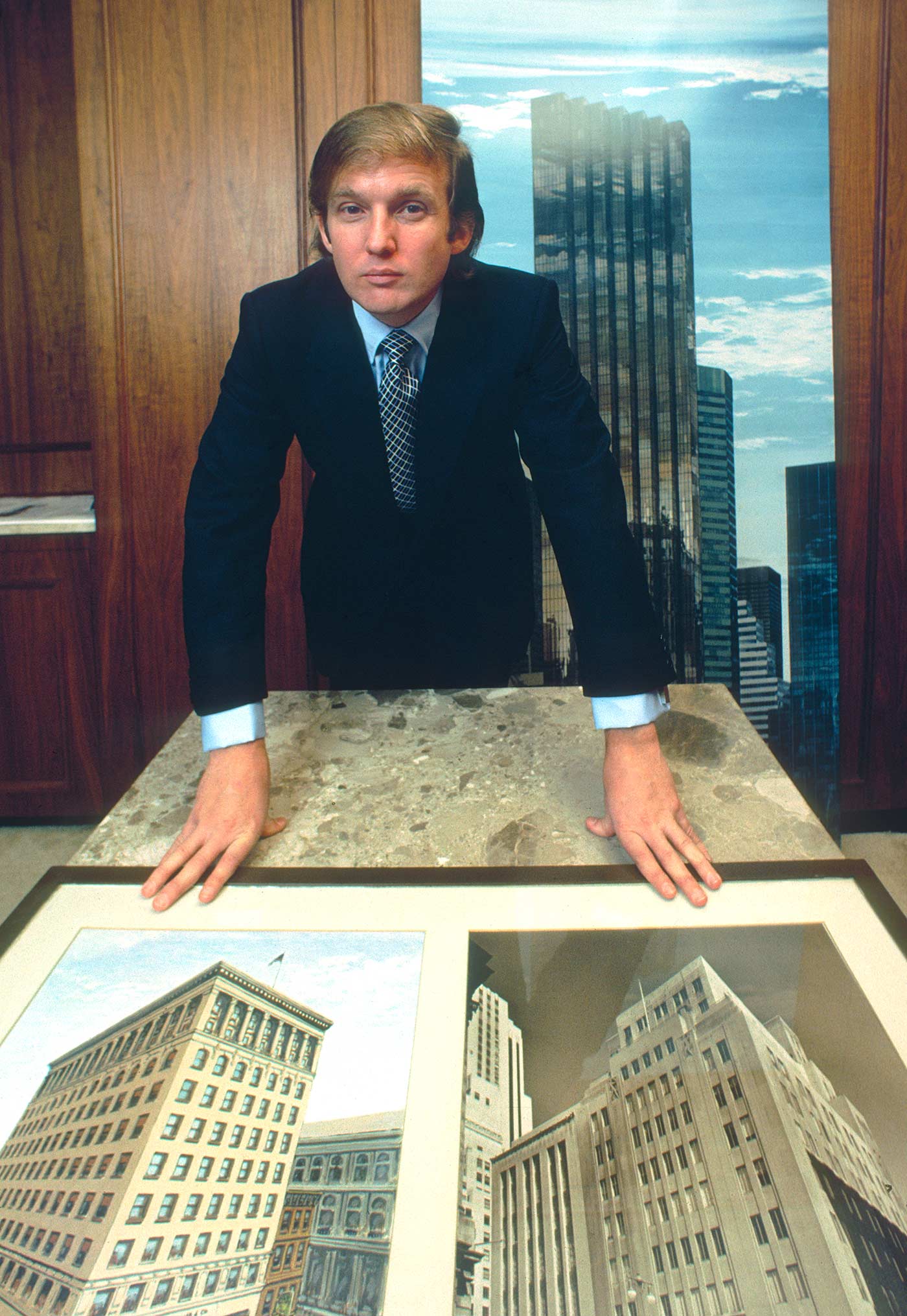 Donald Trump with a rendering of Trump Tower and photographs of the Bonwit Teller Building in New York in 1980