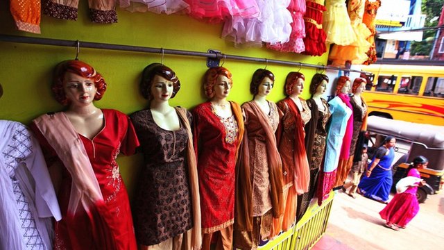 Picture shows a row of mannequins wearing traditional clothes.