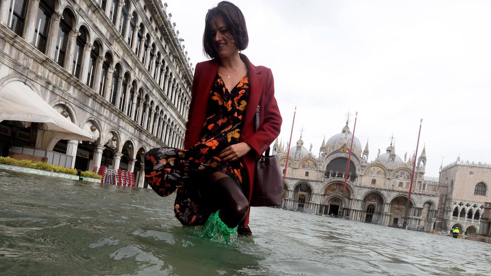 Tourist in flooded water in Venice on 29 October 2018