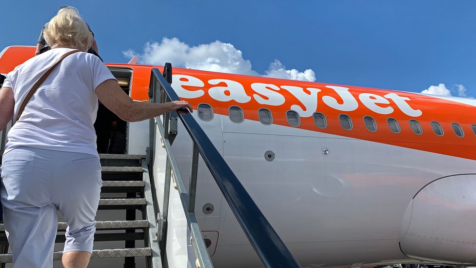 Passenger boards an EasyJet domestic flight at an airport in the United Kingdom on June 15, 2020