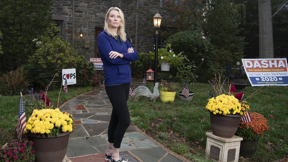 Dasha Pruett, a candidate for Congress and a Trump supporter, standing in front of her house