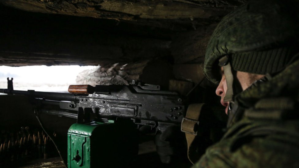A serviceman of the Peoples Militia of the Donetsk People's Republic is seen in a trench shelter on the line of contact between the Ukrainian government forces and the forces of the Donetsk People's Republic in the town of Yasynuvata