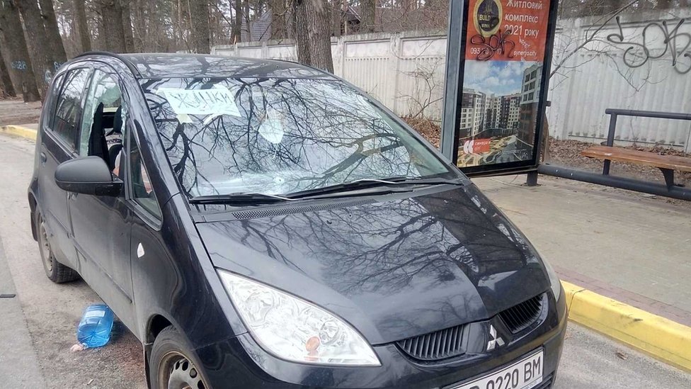 The bodies of a man and a woman in a pink coat were found in this car after the Russians left