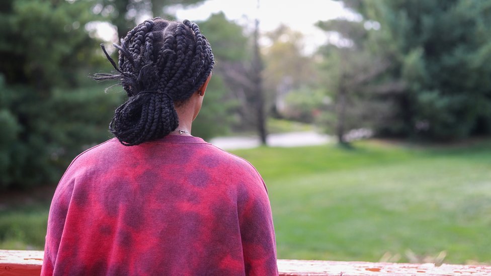 A photo of a black woman from the back