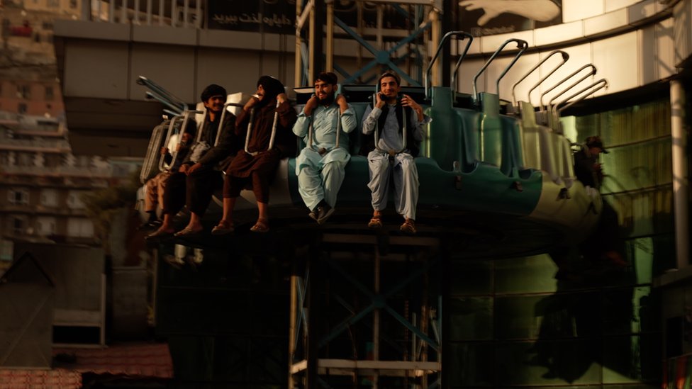 Afghan men on a ride at an amusement park in Kabul