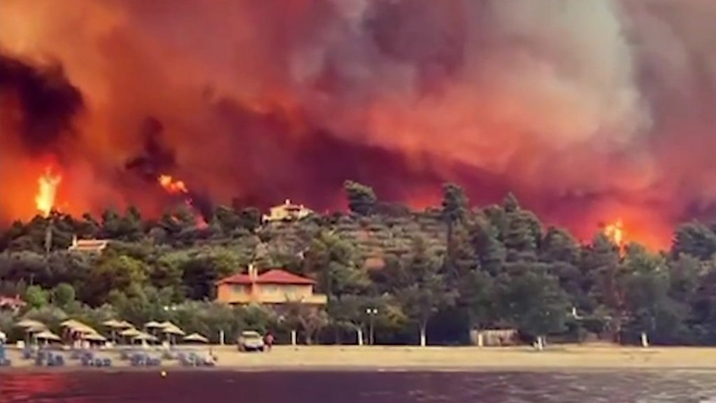 Greece wildfires force people to flee island by boat