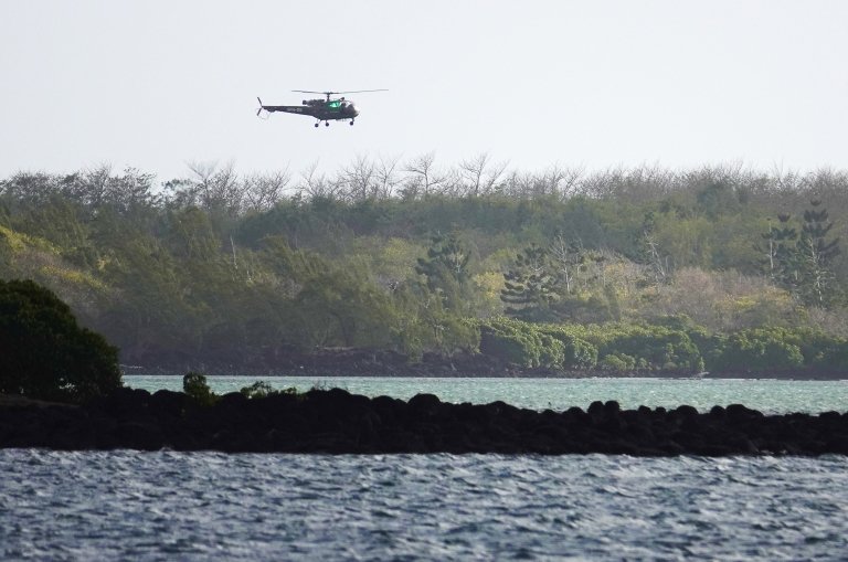 Search and rescue helicopter flies over the site of the collision off Mauritius on 31 August 2020