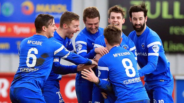 Ballinamallard players celebrate with Stephen O'Flynn who scored on his debut