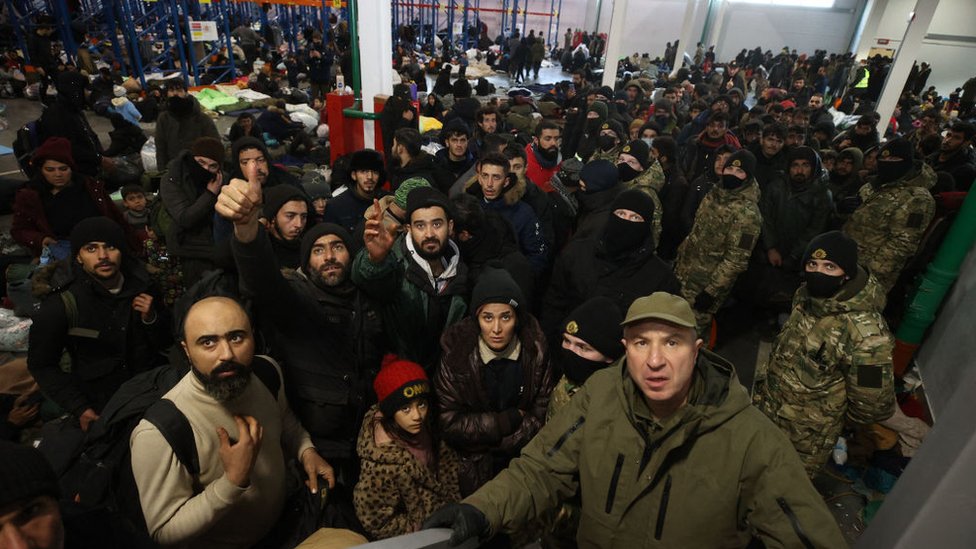 Migrants stay in the transport and logistics centre near the Bruzgi border point