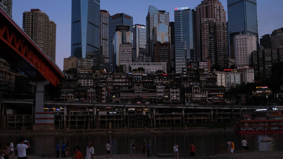 The Hongyadong (Hongya Cave), a comprehensive wooden stilt houses located at the junction of the Yangtze River and the Jialing River, is seen at night on August 21, 2022 in Chongqing, China. Lighting for outdoor wall decoration signs was suspended from Sunday in an effort to save electricity. Public lighting in the scenic area has been reduced by three-quarters and the Hongya Dripping was also temporarily closed
