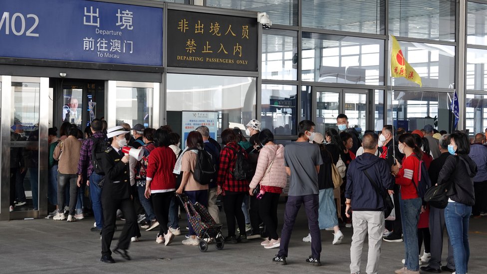 ZHUHAI, CHINA - FEBRUARY 19: Travellers of a tour group heading for Macao queue up to enter the departure area at Hong Kong-Zhuhai-Macau Bridge Zhuhai Port on February 19, 2023 in Zhuhai, Guangdong Province of China. (Photo by VCG/VCG via Getty Images)