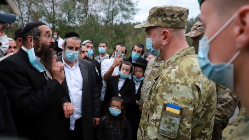 Ukraine's border service head Serhiy Deyneko speaks with Jewish pilgrims