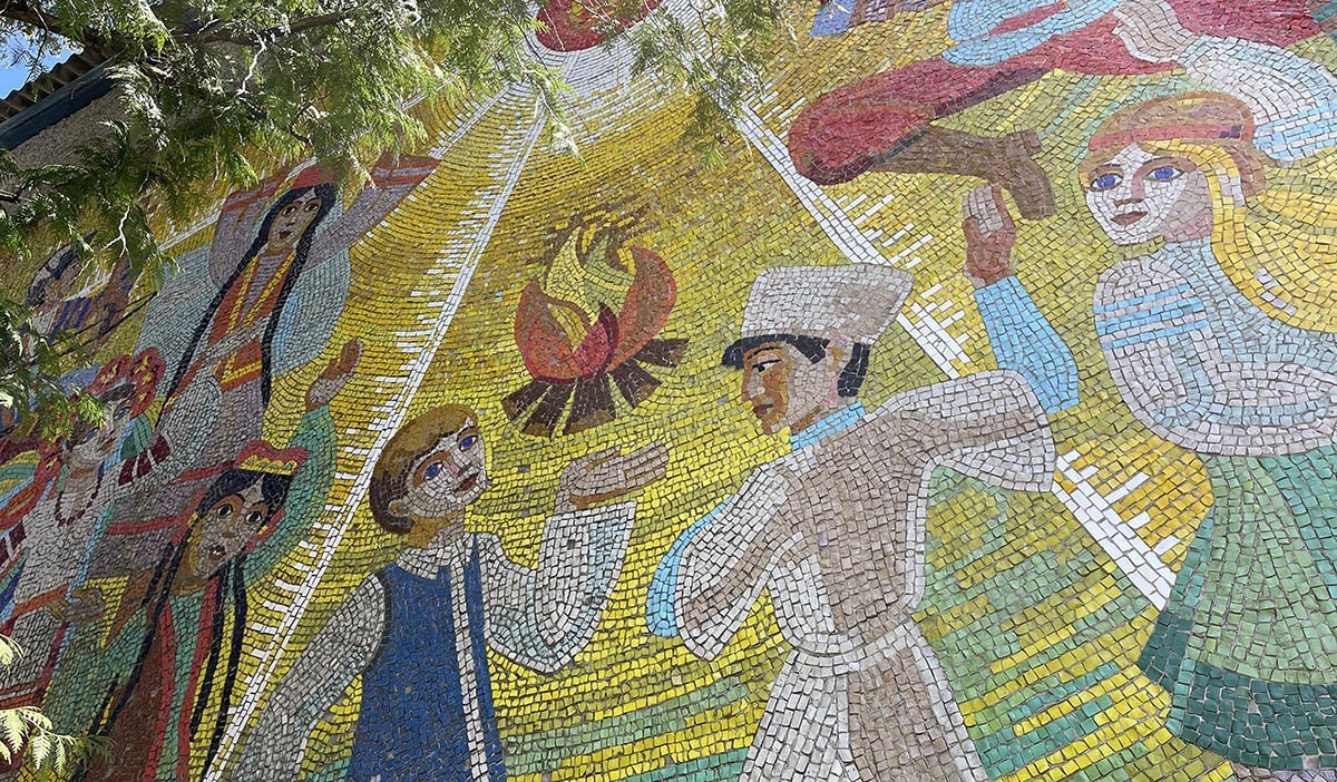 Mosaic of children dancing around a camp fire