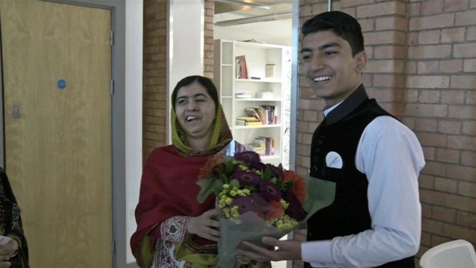 Malala Yousafzai receives flowers from Anwar Ullah