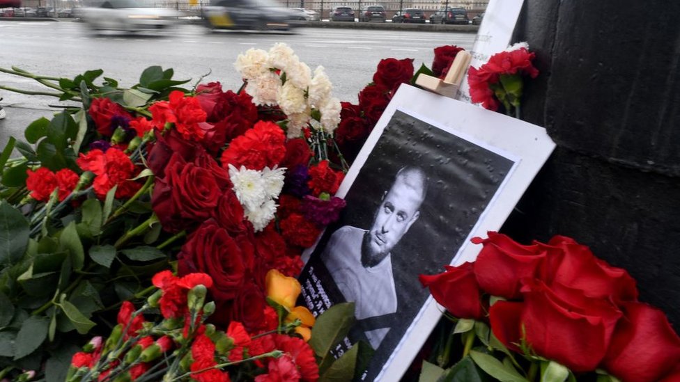 Una imagen de Vladlen Tatarsky rodeada de flores en homenaje por su muerte.