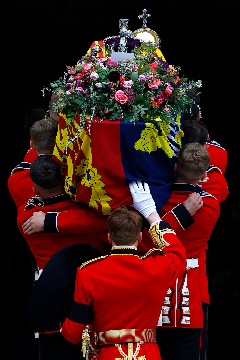 Pall bearers carry the coffin of Queen Elizabeth II, with the Imperial State Crown resting on top, into St. George's Chapel, Windsor - on 19 September 19, 2022.