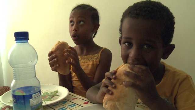 Boy and girl eating bread