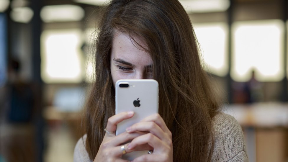 Женщина делает селфи на iPhone