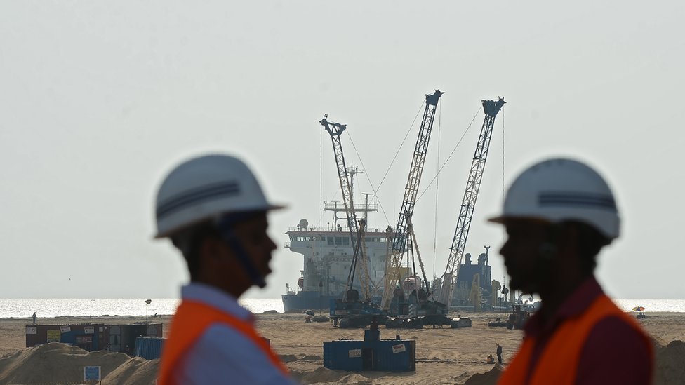 Pumps dredge sand to reclaim land at the site of a Chinese-funded $1.4 billion reclamation next to Colombo's main sea port on January 2, 2018.