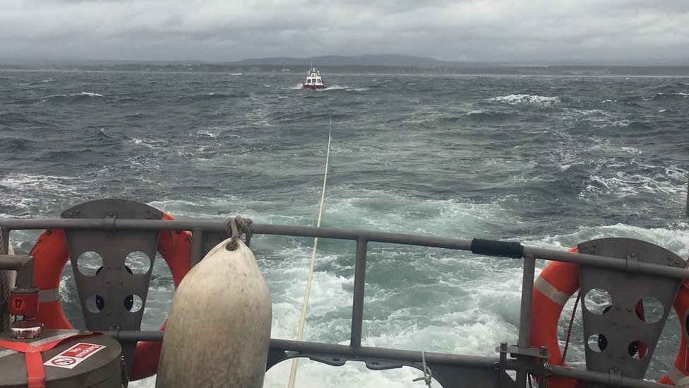 Crew of broken down boat rescued in 'punishing conditions' - BBC News