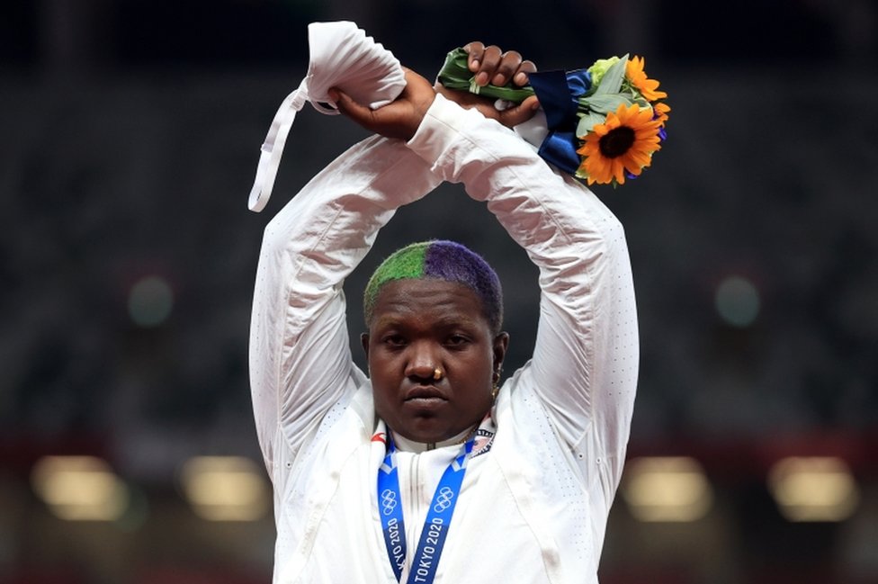Shot put silver medallist Raven Saunders of the United States gestures on the podium