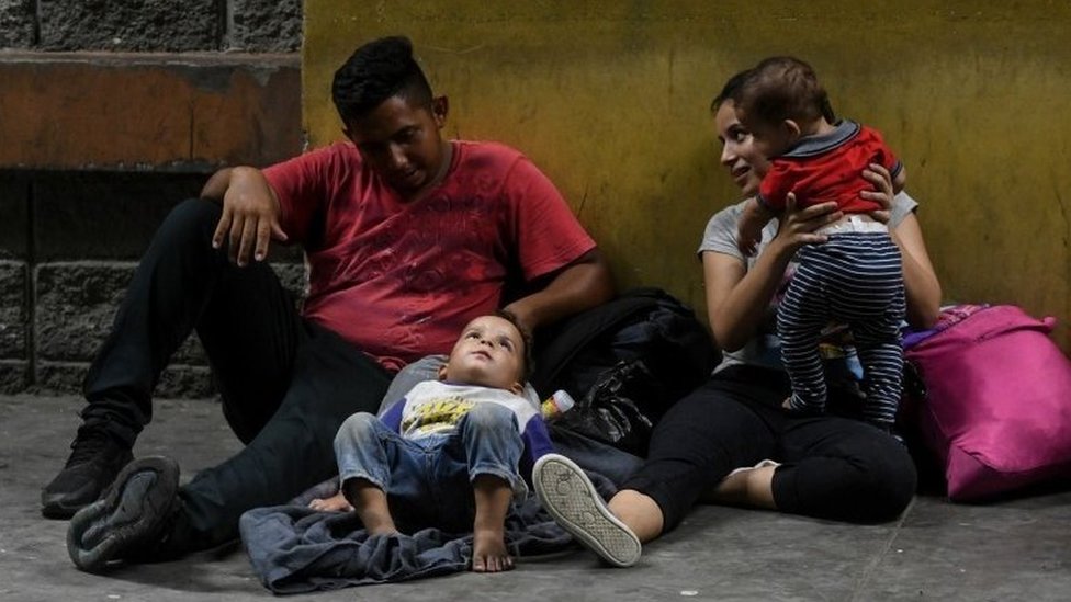 Семьи из Гондураса ждут, чтобы сесть в автобус, который отправляется из столичного центра Сан-Педро-Сула, в 300 км к северу от Тегусигальпы, чтобы отправиться к границе с Гватемалой 9 апреля 2019 г.