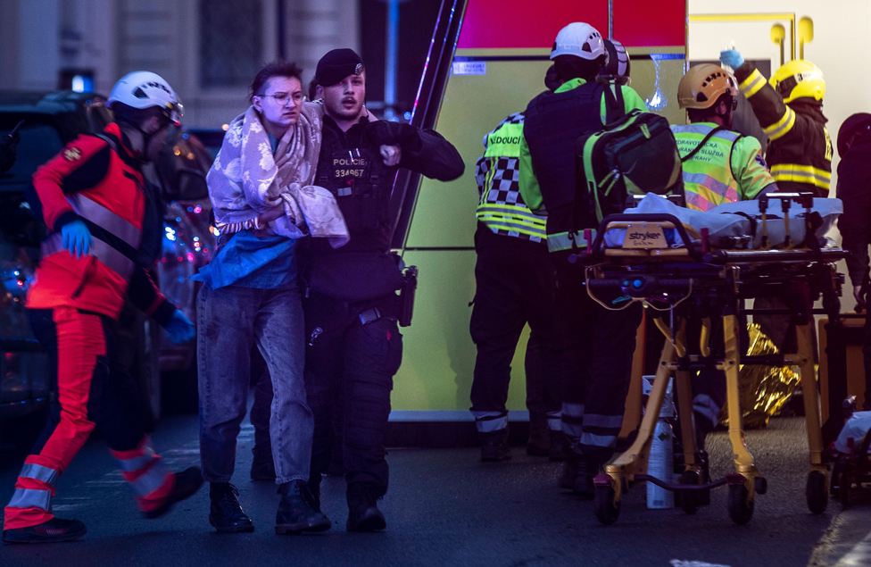 Emergency service members help people hurt in a shooting at the Faculty of Arts has 14 victims, there will be a state mourning on Saturday, center, Prague, Czech republic - 21 Dec 2023
