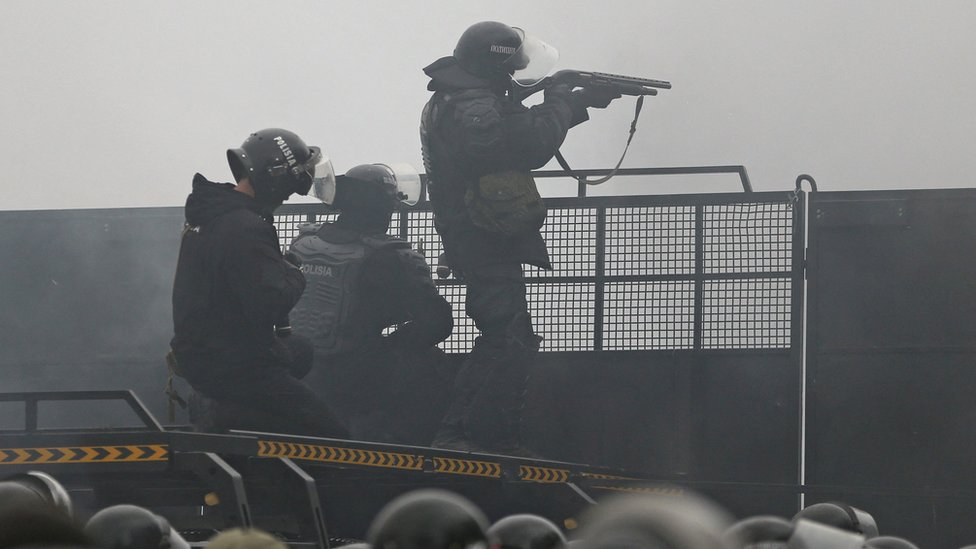 Police seen at a barricade in Almaty on Wednesday