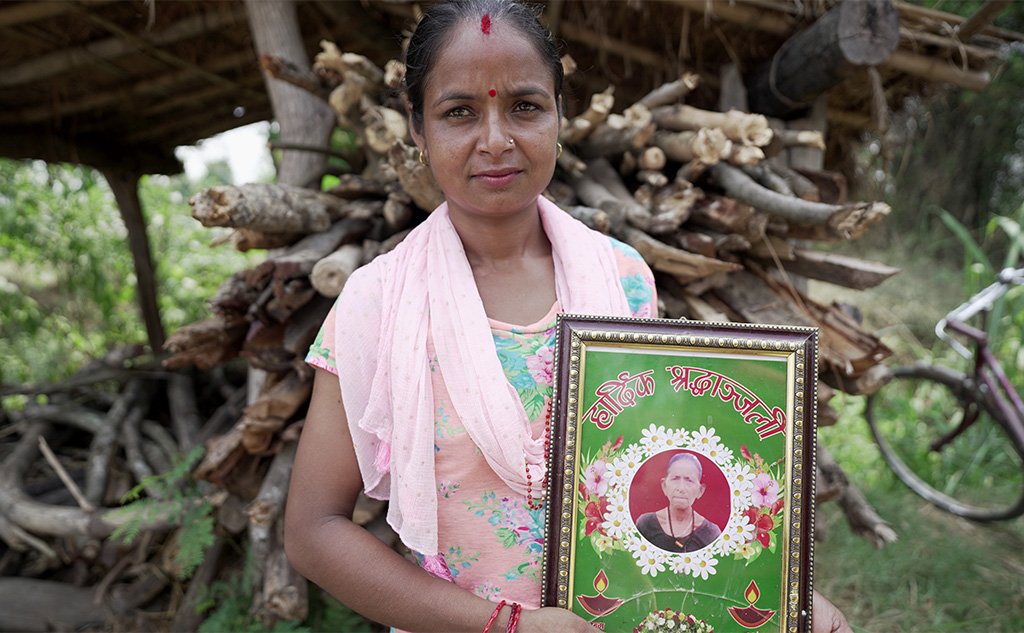 Samjhana holds a photo of her mother-in-law
