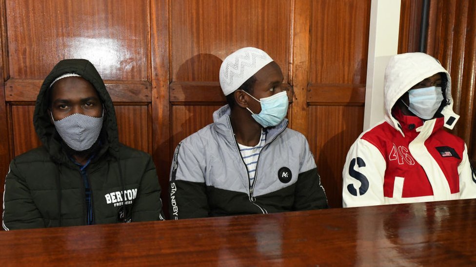 Hussein Hassann Mustafah, Liban Abdullah Omar, and Mohamed Ahmed who are charged with aiding the gunmen involved in the Westgate Mall attack of September 2013, sit in the dock during their appearance for their case at the Milimani court in Nairobi on October 5, 2020.