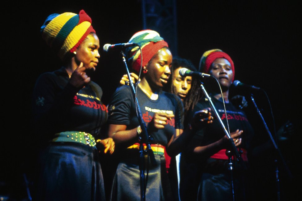 Bob Marley and the I-Threes perform together at the Rainbow Theatre in London in 1977