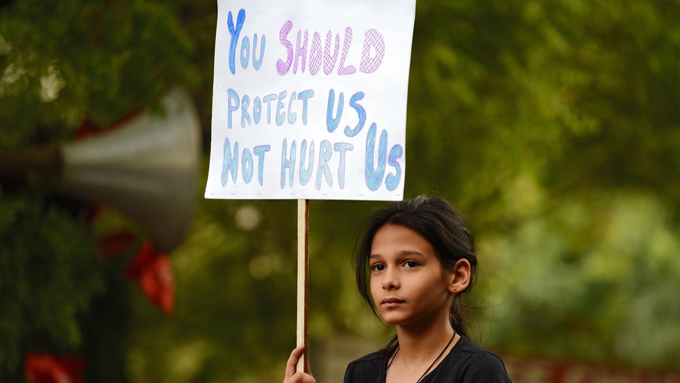 Индийский демонстрант держит плакат во время безмолвной акции протеста «Не от моего имени» в поддержку жертв изнасилования.