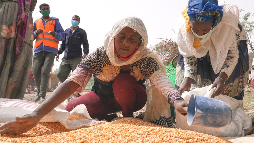 نساء يوزعن مساعدات غذائية