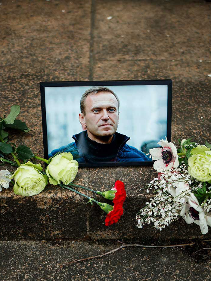 A portrait of Alexey Navalny is displayed with flowers near the Russian Embassy in Paris, France - 16 February 2024