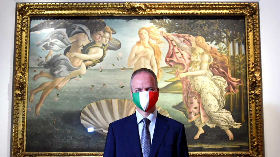 Director of the Uffizi Gallery Eike Dieter Schmidt poses with a face mask in front The Birth of Venus painting by Sandro Botticelli