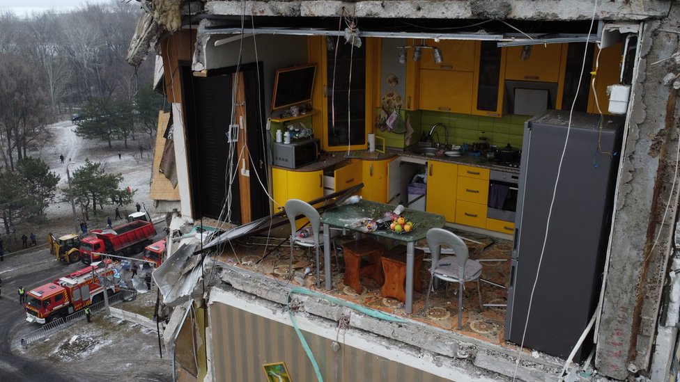 The yellow kitchen seen with its wall blown off