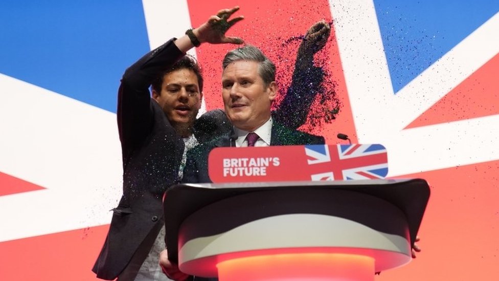 Keir Starmer speech disrupted as protester glitter-bombs Labour leader -  BBC News
