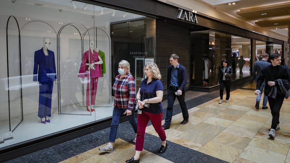 People walk in front of a closed Zara shop at a shopping centre in Moscow, Russia, 26 May 2022