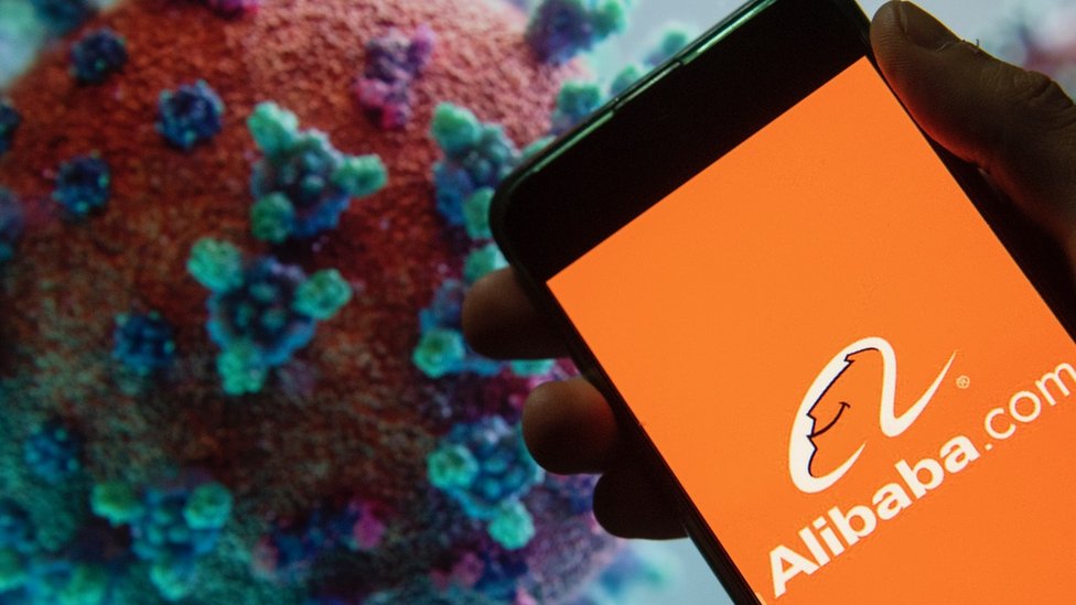 Alibaba on phone with coronavirus molecule in background