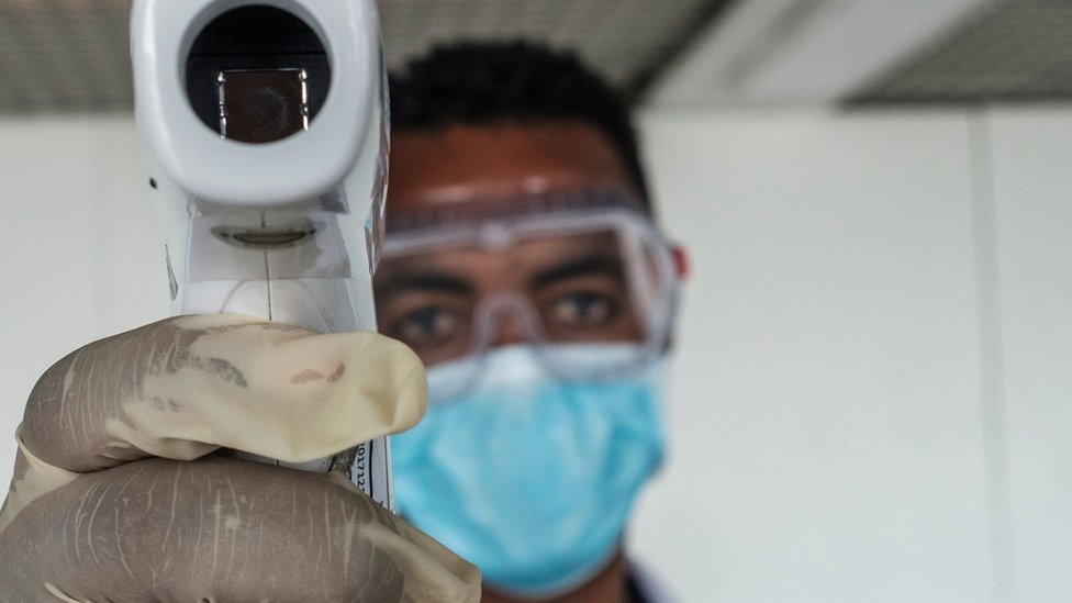 A health worker taking temperatures at the main airport in Ethiopia - March 2020