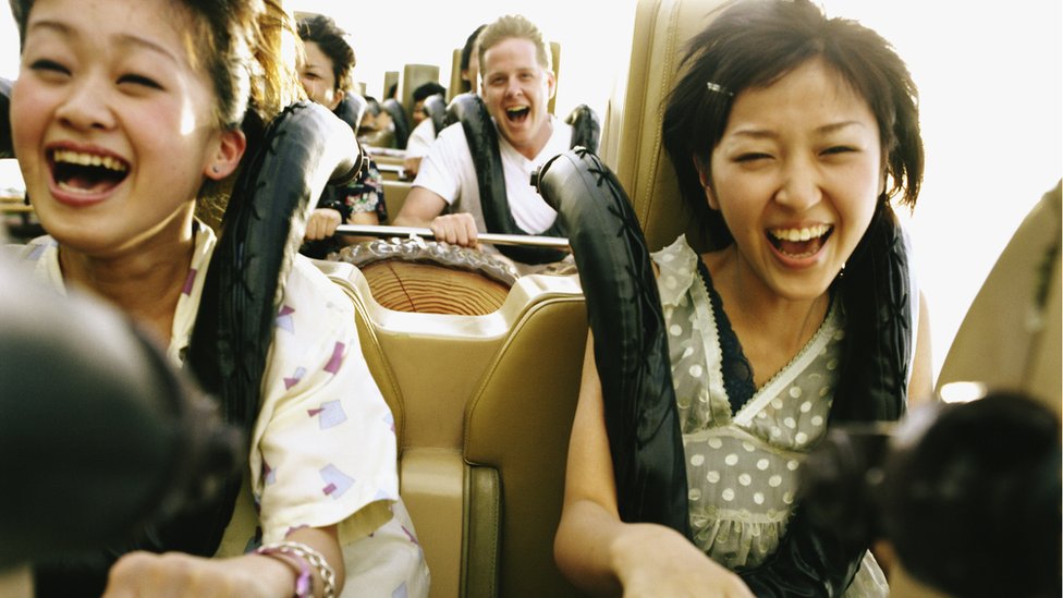 Close shot of people screaming on rollercoaster