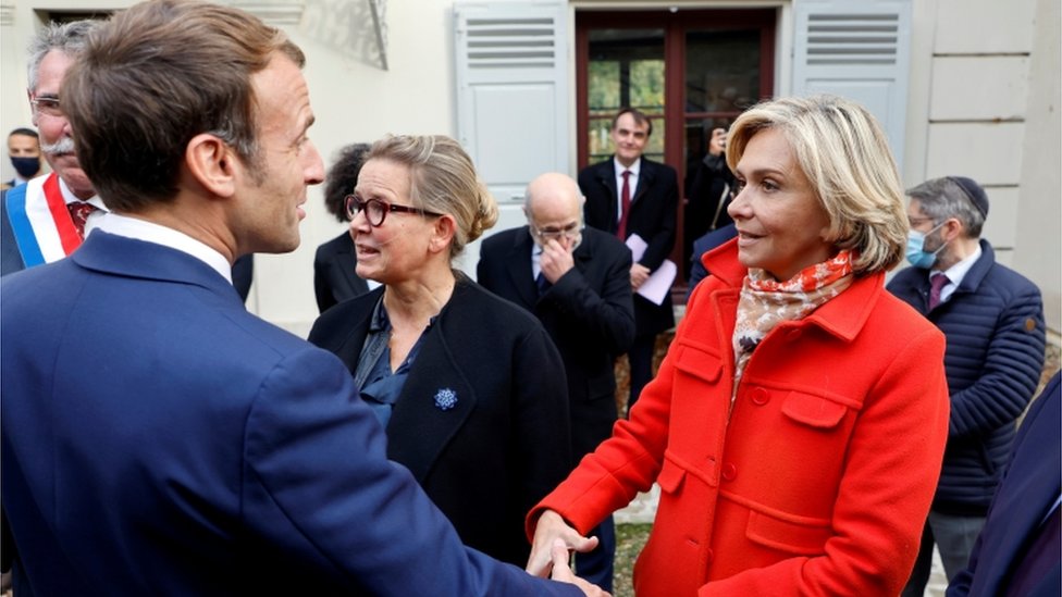 French President Emmanuel Macron greets Ile de France regional president and candidate for the French right-wing Les Republicains primary election Valerie Pecresse at the Emile Zola house in Medan, near Paris, on October 26, 2021