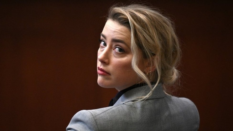 Amber Heard sits in a Virginia court for the start of her defamation trial against Johnny Depp