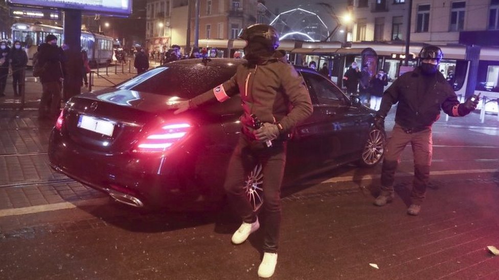 The car of Belgium's King Philippe is protected by police on his way back from Brussels to Laeken Palace