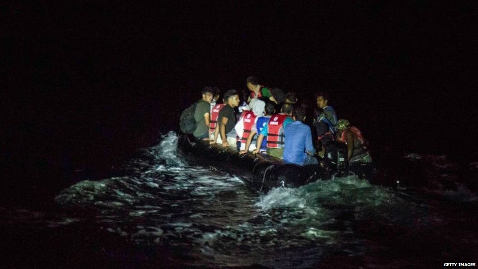 A rubber dinghy full of migrants crossing to the Greek island of Lesvos at night